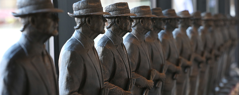Statues of Bear Bryant lined up in a row