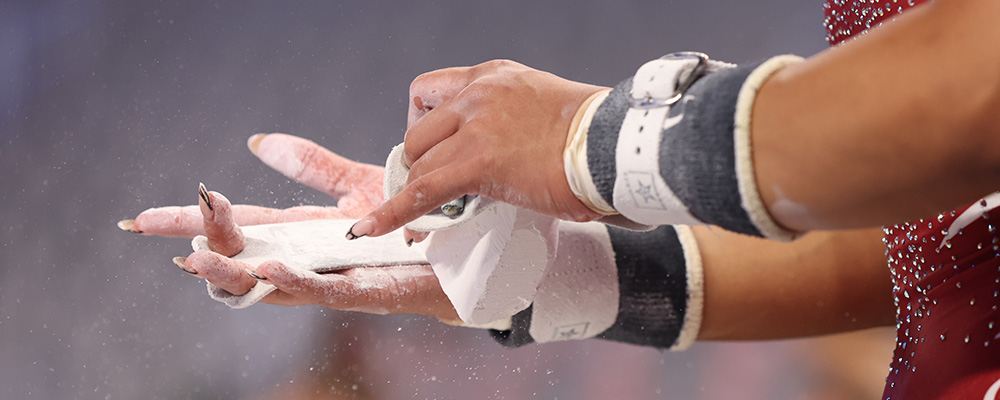 Gymnast chalking her hands