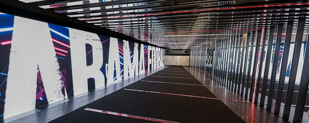 Football tunnel lit up in lights