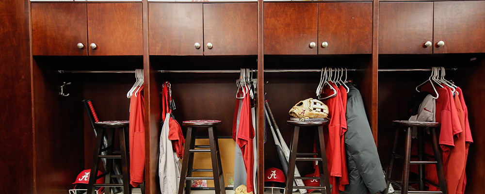 Wooden lockers with uniforms hanging