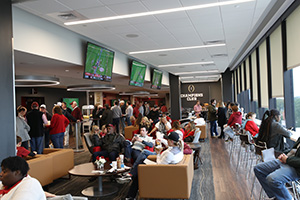 Seating group of chairs and counter seating lining the floor-to-ceiling windows