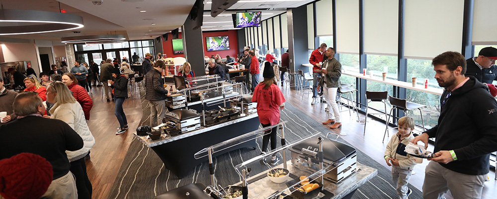 Fans milling about, serving themselves from several buffets