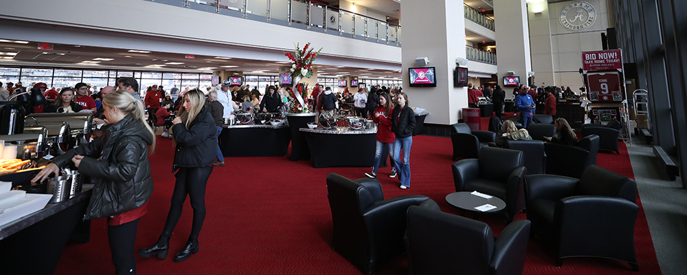 People milling about the buffets with leather chairs grouped together around small tables