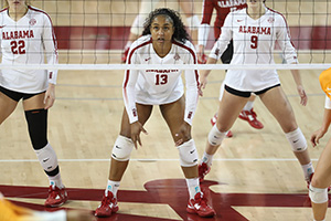 Alyiah Wells crouched ready to jump and hit the ball